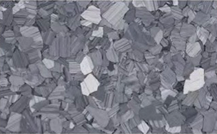 A close-up view of a surface covered with irregular, flat, gray and white stone or tile fragments.