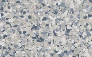 Close-up of a speckled gray, white, and blue terrazzo or epoxy floor surface with irregularly shaped chips.